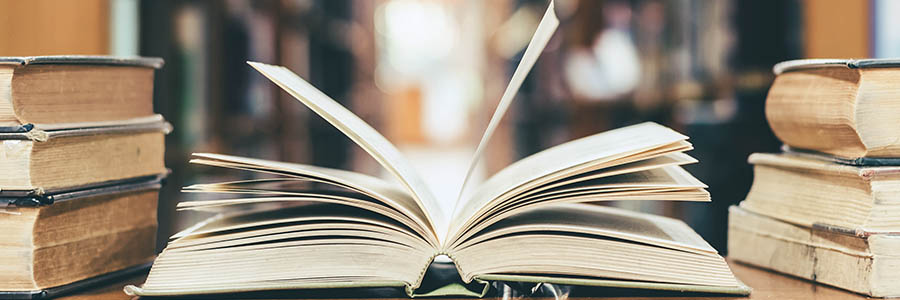 An open book on a table in a library.